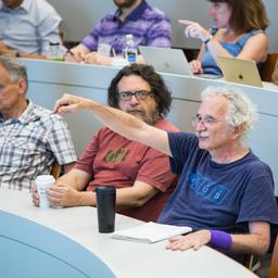Doron Zeilberger asking Bruno Salvy a question, during his invited talk "Diagonals- Combinatorics, Asymptotics and Computer Algebra," while Daniel Panario watches inquisitive.